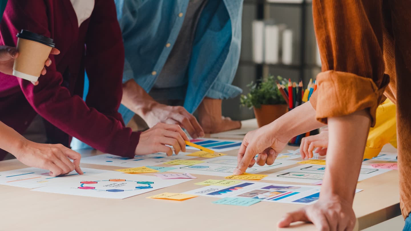 people brainstorming in a workshop, writing on post-its